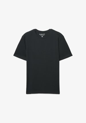 T-shirt nera in cotone a taglio aderente, con scollo rotondo e maniche corte. Etichetta con la scritta "SLIM FIT TERRANOVA XL."