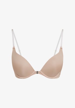 Soutien-gorge beige rembourré avec fermeture à l'avant et fines bretelles transparentes réglables sur fond blanc.