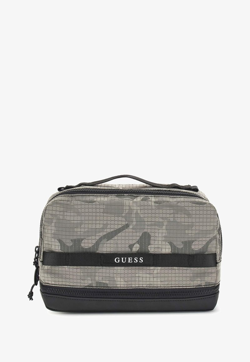 Hall gris kamuflaažiga tualettkunstide kott, mis on valmistatud tekstureeritud kangast, musta tõmbluku ja logosildiga. Kompaktne, ristkülikukujuline ja tugeva käepidemega.