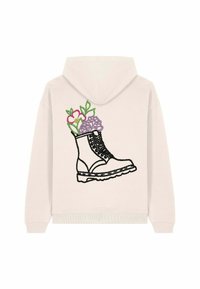 Felpa chiara con cappuccio, caratterizzata da un ricamo di un stivale nero con motivi floreali in rosa e viola, situato sulla schiena.