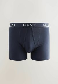 Boxer-briefs bleu marine en tissu lisse, dotés d'une ceinture élastique grise contrastante avec "NEXT" imprimé en blanc.