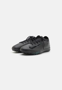 Black athletic shoes with textured upper, tonal swoosh detailing, and contrasting teal accents. Features lace-up design and rubber sole.
