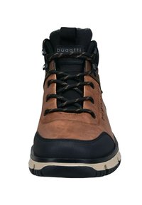 Scarponi da trekking in pelle marrone con accenti neri, lati testurizzati e allacciatura robusta. Presentano una suola beige e un dettaglio del logo sulla linguetta.