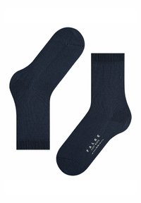 Un paio di calze di lana blu scuro, con polsini a costine, una calza che mostra il testo stampato con la taglia e il marchio sulla suola.