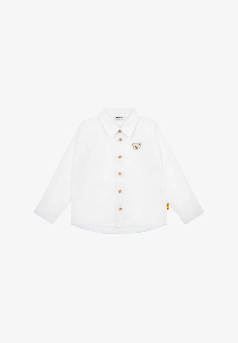 Witte langemouwen shirt met een puntige kraag, gouden knopen en een berenmotief op de linkerborst. Met een ronde zoom en een zijlabel.