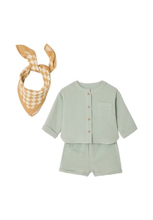 Light green cotton baby outfit with long-sleeve buttoned top and matching shorts, paired with a beige and white checkered bandana.