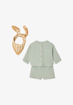 Light green cotton baby outfit with long-sleeve buttoned top and matching shorts, paired with a beige and white checkered bandana.