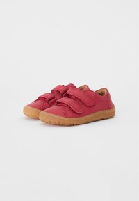 Red leather shoes with two Velcro straps, rounded toe, and a textured gum rubber sole. Features a smooth upper and reinforced stitching.