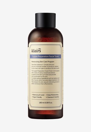 Bruine glazen fles met een zwarte dop, voorzien van een beige label met blauwe accenten. Bevat 180 ml gezichts toner voor hydratatie en balans van de huid.