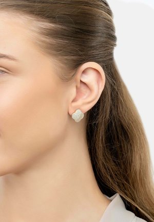 Gold-tone earrings featuring a textured floral design with small clear crystals arranged in a petal pattern.