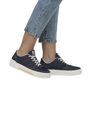 Denim sneakers featuring a dark blue color, white laces, and rubber sole with textured detailing. Accented with subtle stitching patterns.