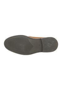 Braunes Wildleder-Schuh mit einer glatten, schwarzen Gummisohle. Die Sohle weist ein strukturiertes Muster für Traktion und Langlebigkeit auf.