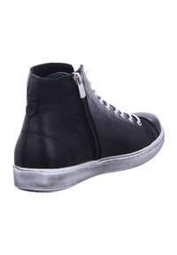 Black leather high-top sneakers with a zip closure, white laces, and a rubber sole featuring a striped pattern.