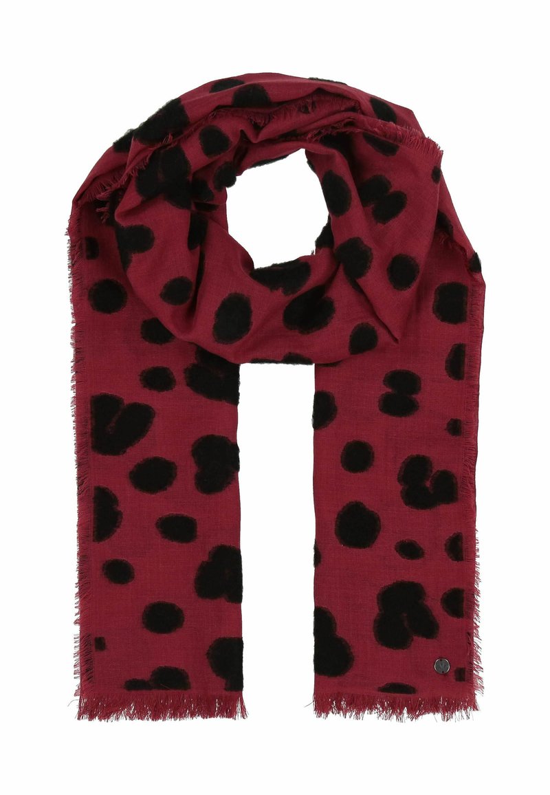Écharpe rouge avec de grands pois noirs, bords effilochés, en matériau doux, conçue pour la chaleur et le style.