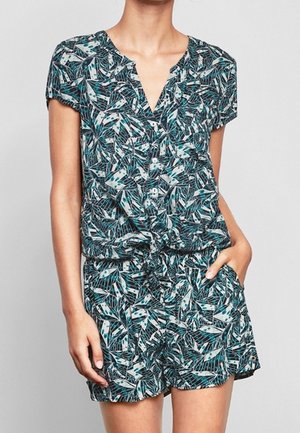 Short-sleeve, navy romper with a tropical leaf pattern, featuring a button-up front and drawstring waist. Lightweight fabric with a relaxed fit.