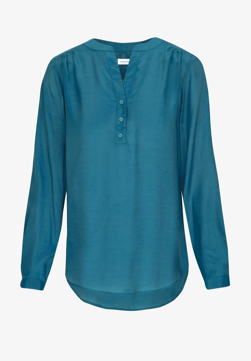 Blusa lunga teal a maniche lunghe con scollo a V, placket con tre bottoni, dettaglio delle spalle arricciato e orlo curvo.
