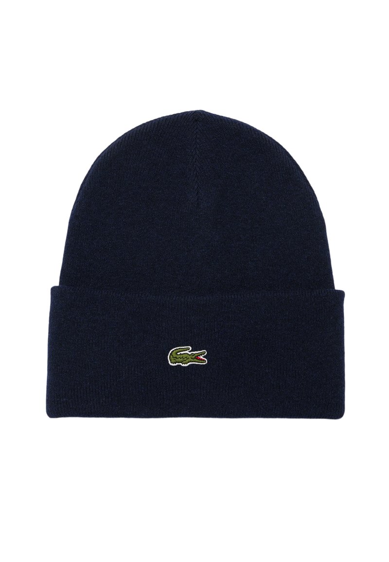 Bonnet en tricot bleu marine avec un revers et un petit logo en crocodile vert brodé à l'avant. Texture douce et design ajusté.