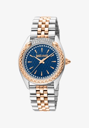 Orologio in metallo argento e rosé con un quadrante blu textured, dettagli in cristallo e marcatori audaci. Presenta un bracciale con maglie e un design della cassa distintivo.