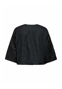 Top negro de gran tamaño con una superficie texturizada que presenta un patrón floral. Corte relajado y mangas anchas. Vista trasera mostrada.