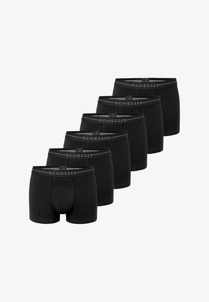 Sorte bomuldsboxershorts med en glat tekstur og gråt elastikbånd mærket "SCHIESSER." Seks par vist i en række.
