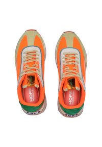 Baskets avec un schéma de couleurs vif comprenant des accents orange, vert et beige, des matériaux texturés et un patch logo réfléchissant.