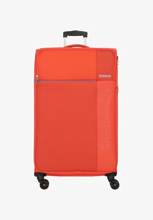Red soft-shell suitcase with a textured finish, top carrying handle, telescopic handle, and four black spinner wheels. Features a zipper pocket.
