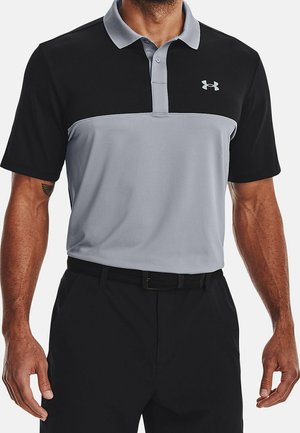 Man wearing black and gray short-sleeve polo shirt with collar and Under Armour logo on chest, paired with black pants and belt.