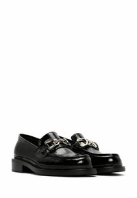 Black leather loafers with a glossy finish, featuring metal chain hardware on the front and a contrasting black sole, rounded toe design.