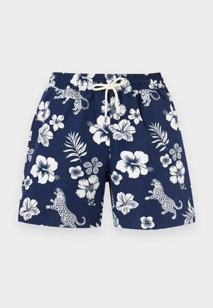 Pantaloncini da bagno blu navy con fiori tropicali bianchi, foglie di palma e stampe di leopardi saltanti, dotati di una vita elastica e coulisse bianca.