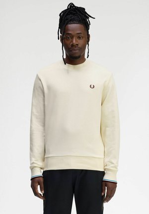 Sudadera color crema hecha de una tela suave, con cuello redondo, puños acanalados y un pequeño logo burdeos en el pecho.