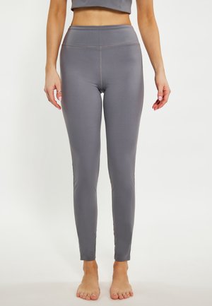 Szürke, testhezálló leggings, sima anyagból, magas derékkal. Letisztult dizájn, nincs látható minta.