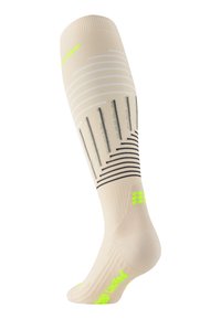 Compressiekousen in beige met zwarte en neon groene accenten. Verticale strepen en gestructureerde hak; nauwsluitend ontwerp voor ondersteuning en comfort.