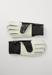Black and white gloves featuring a smooth black synthetic material on the back and white textured palms with structured finger design.