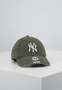 Zelená baseballová čepice vyrobená z bavlny s bílou vyšívanou „NY“ logem a nastavovacím páskem. Přední zakřivený kšilt, klasický design pěti panelů.