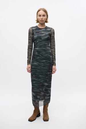Long-sleeve dress in dark green with a wavy pattern, made of sheer material. Features a fitted silhouette and a below-knee length.