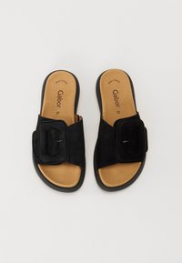 Sandali a slitta neri in suede con larghe fasce e un accento rettangolare. Sottopiede imbottito color tan con stampa, dotato di suola piatta in gomma. Taglia 37.