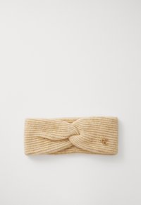 Knit headband in light beige, featuring a twisted design at the front and subtle ribbing. Small gold logo accent on the side.