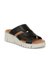 Sandali slide neri in pelle con cinturini incrociati, soletta in sughero sagomata e una spessa suola piattaforma bianca con superficie testurizzata.