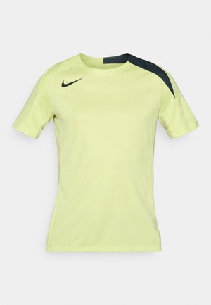 Lühikeste varrukatega Nike spordisärk erksas kollases värvitoonis mustade aktsentidega õlgadel. Sile ja kerge kangas, millel on istuv lõige.