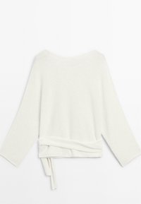 White knit sweater with long sleeves, wide neckline, and a wrap-around tie detail at the waist. Soft texture and minimalist design.