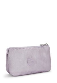 Lilac fabric pouch with a zip closure and rounded shape. Features a embossed logo on the front. Smooth texture and stitched edges.