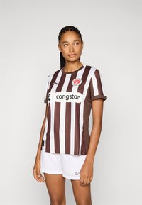 Brown and white striped soccer jersey with short sleeves, featuring a round neck, logo on the chest, and sponsor text in the center.
