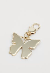 Gold-tone butterfly charm with a smooth, metallic surface and a lobster clasp attachment. Features wing outlines and a shiny finish.