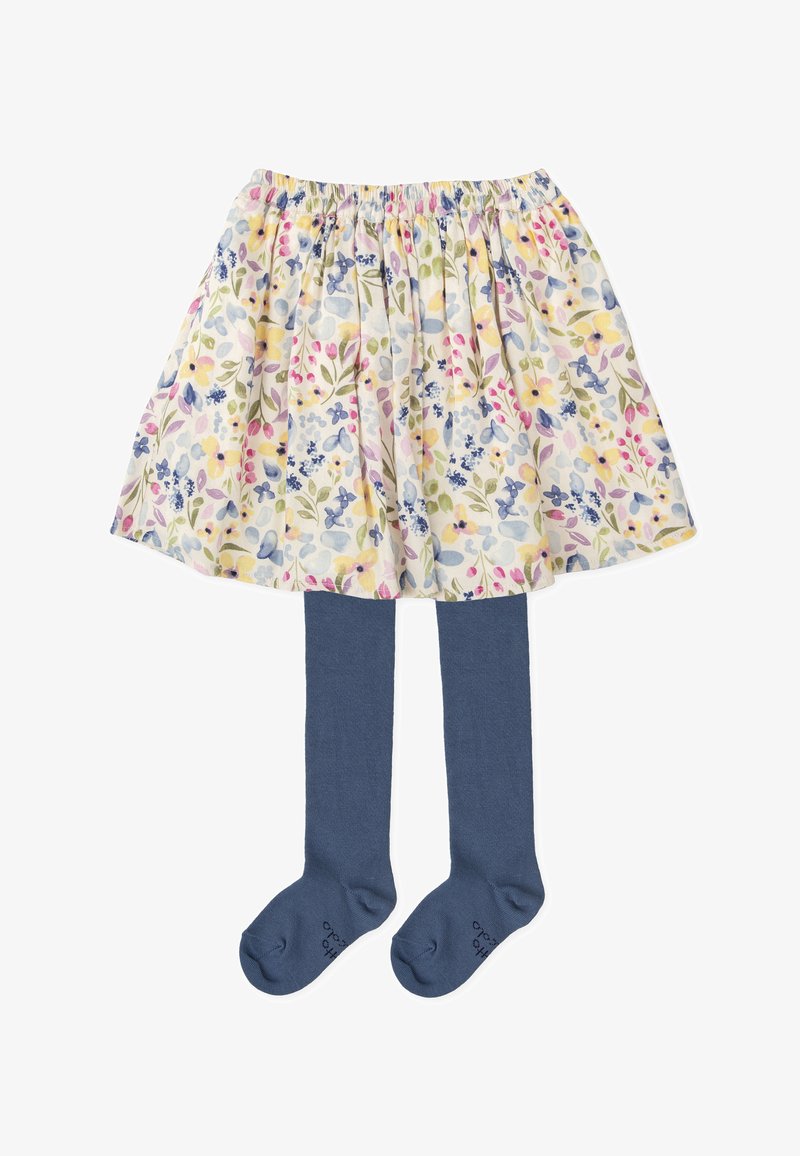 Jupe fleurie avec une taille élastique, présentant des couleurs pastel et des motifs complexes. Associée à des collants bleu marine, en tissu doux.