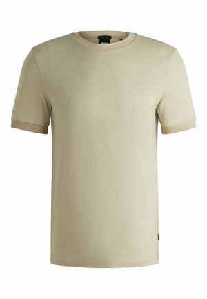 T-shirt beige a maniche corte con colletto tondo, tessuto texturizzato e polsini a contrasto. Include un piccolo etichetta del marchio di lato.