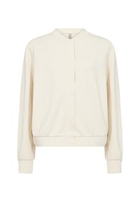 Giacca leggera color crema con colletto rialzato, maniche lunghe e polsini e orlo elasticizzati. Presenta un'abbottonatura frontale minimale.