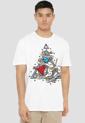 Man wearing white T-shirt with a blue triangle, red cloak, wand, diamond, and "Three Brothers" Deathly Hallows themed banner design.