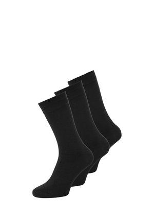 Chaussettes en coton noir, trois paires, longueur mi-mollet, texture lisse, bords élastiques pour un maintien sûr, sans motifs ni accents visibles.