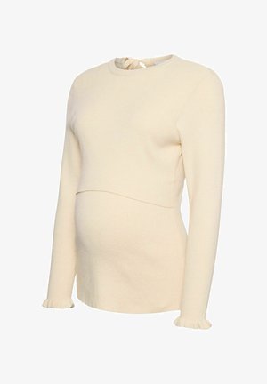 Kreminė ribota nėščiųjų megztinis su ilgomis rankovėmis ir pūkuotais rankogaliais, su raukšlėta iškirpte, sukurtas pritaikytai siluetai.