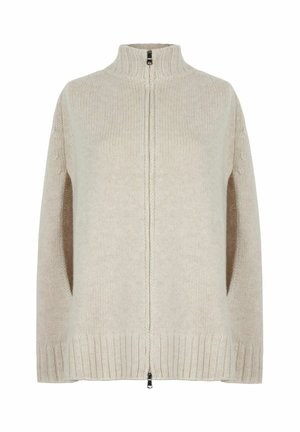 Cremefarvet strikket sweater med høj krave, lynlås og sidelommer. Har ribbede cuffs og kant, tekstureret stof.